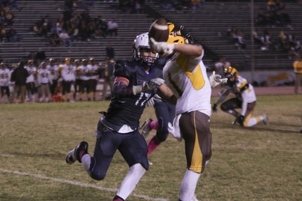 Lemoore's Jacob Gonsalves keys on the Golden West quarterback. 